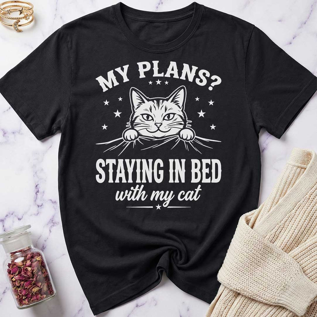 Black t-shirt with a cat graphic and text on a marble surface