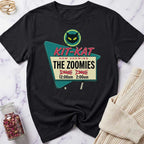 Black t-shirt with 'Kit-Kat Now Showing The Zoomies' graphic design on a marble surface.