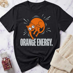 Black t-shirt with orange cat graphic and 'Orange Energy' text on a marble surface.