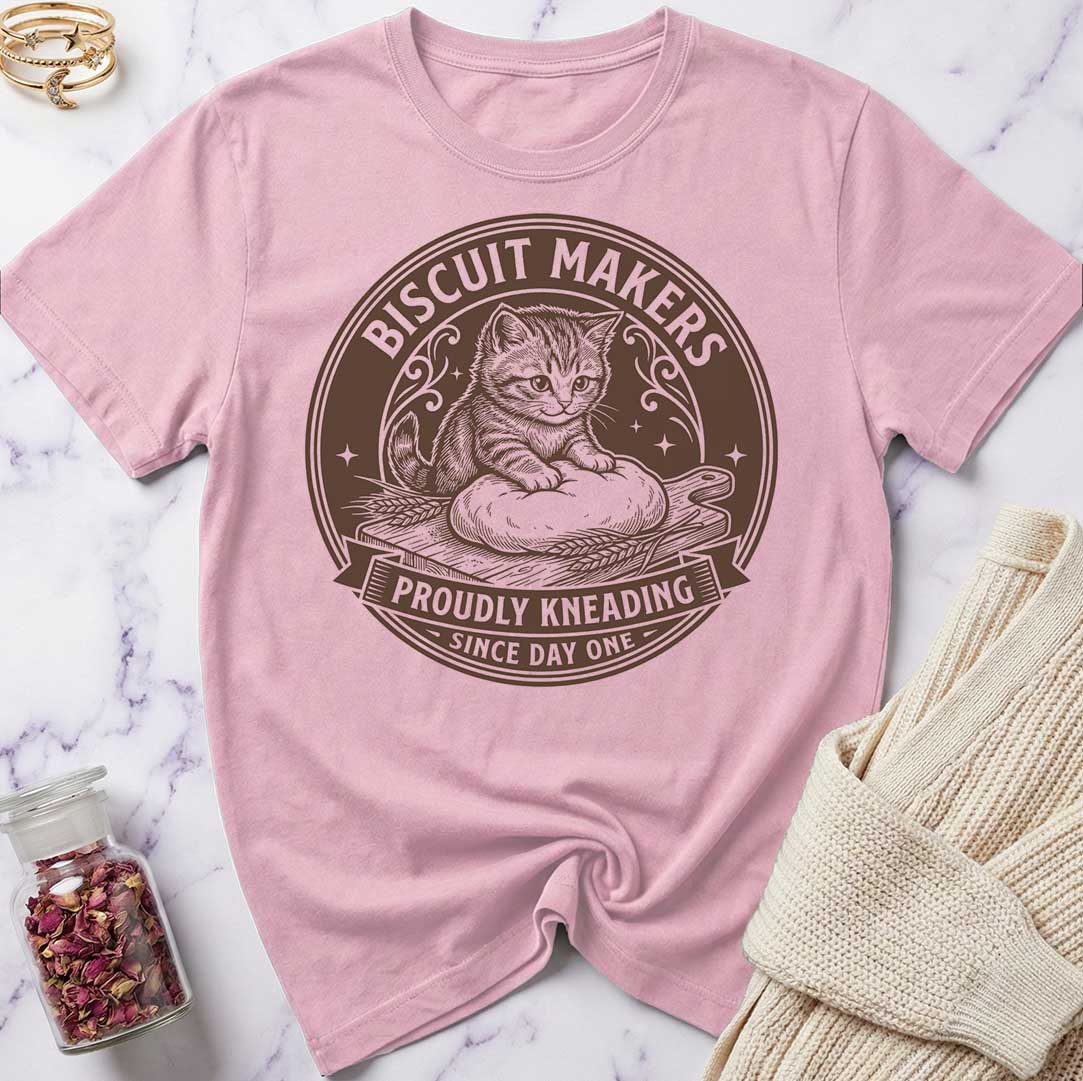 Pink t-shirt with a cat graphic and text on a marble surface