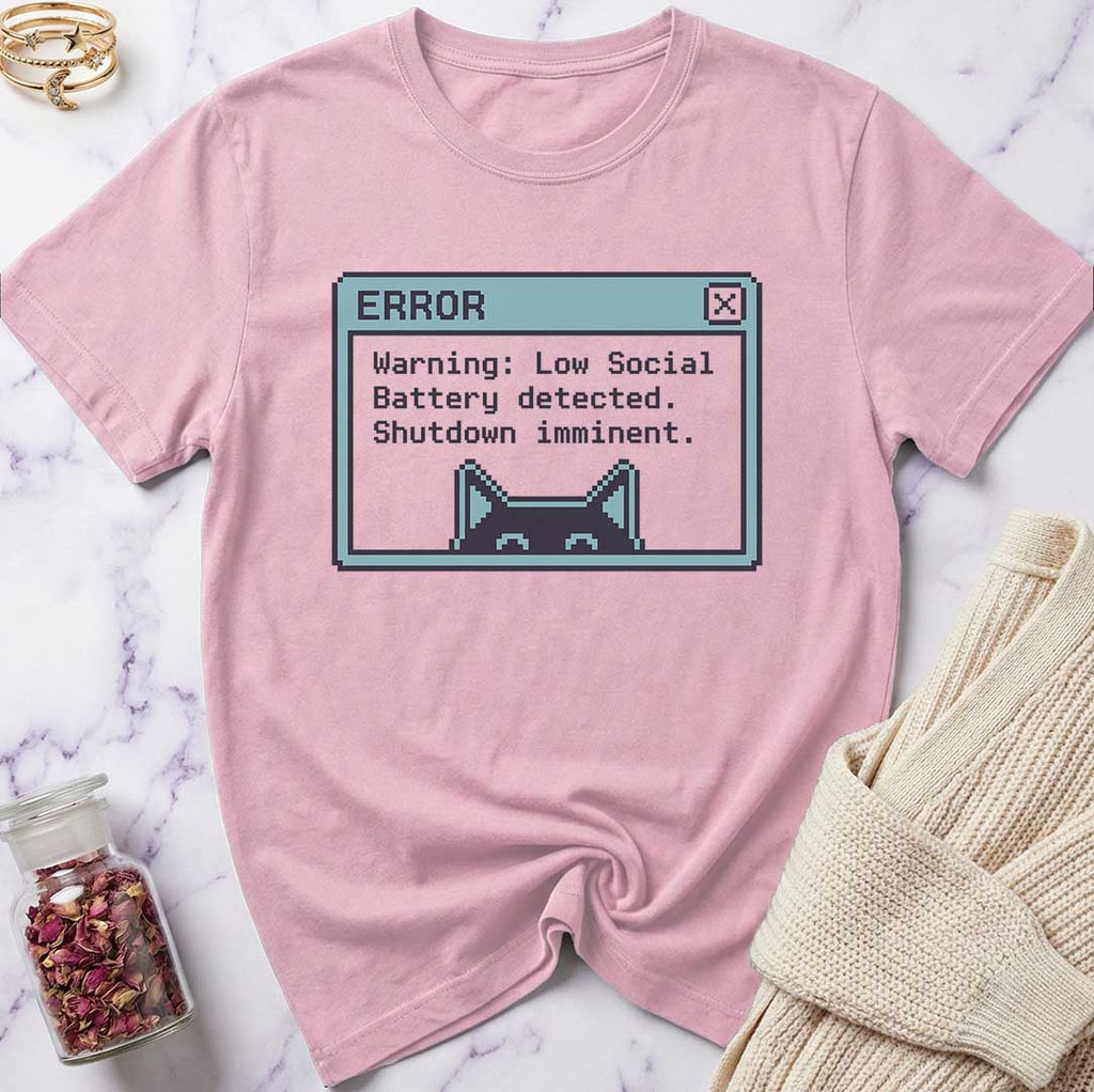 Pink t-shirt with a graphic design on a marble surface
