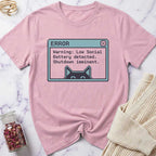 Pink t-shirt with a graphic design on a marble surface
