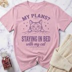 Pink t-shirt with a cat graphic and text on a marble surface