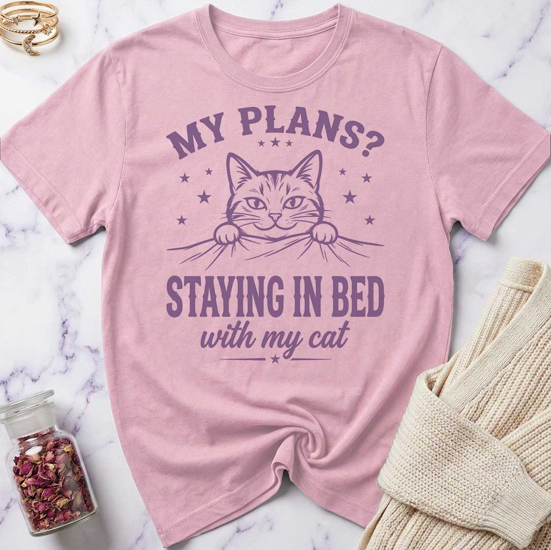 Pink t-shirt with a cat graphic and text on a marble surface
