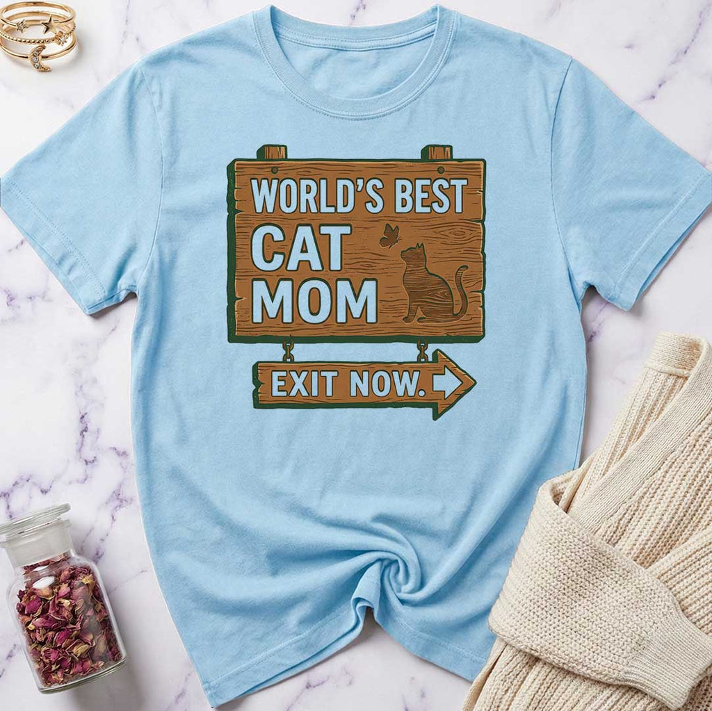 Light blue t-shirt with 'World's Best Cat Mom Exit Now' graphic on a marble surface.