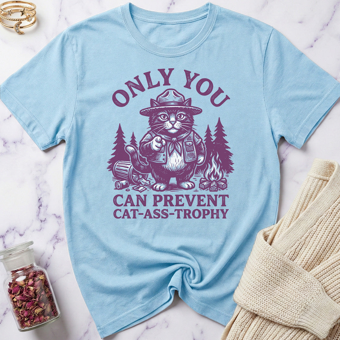Light blue t-shirt with a graphic of a cat in a hat and text on a marble surface.