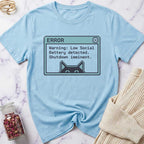 Light blue t-shirt with a graphic design on a marble surface