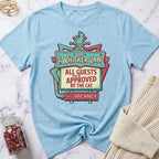 Light blue t-shirt with 'The Whisker Inn' graphic design on a marble surface.