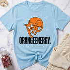 Light blue t-shirt with an orange cat graphic and 'Orange Energy' text on a marble surface.