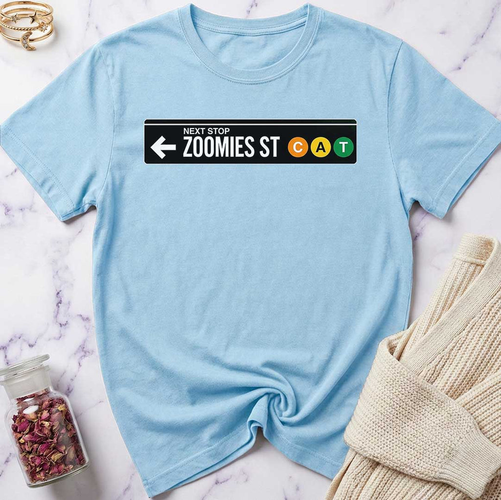 Light blue t-shirt with a graphic design on a marble surface