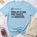 Light blue t-shirt with humorous text design on a marble surface.