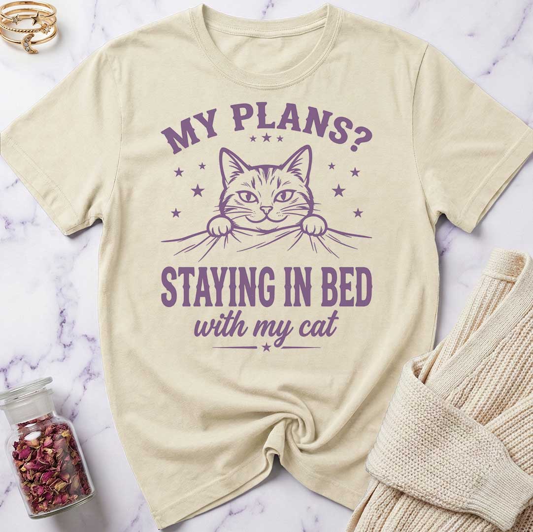 Beige t-shirt with a cat graphic and text on a marble surface