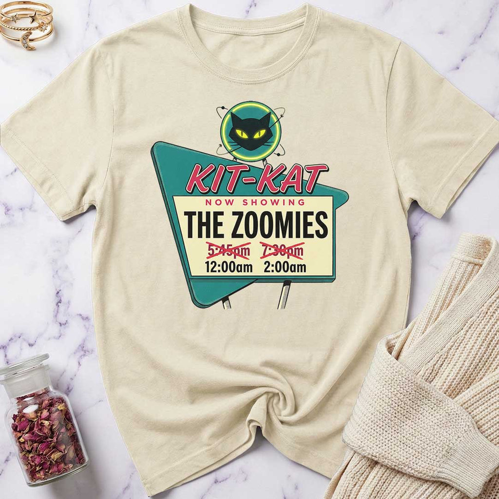 Beige t-shirt with a movie theater-themed graphic on a marble surface.