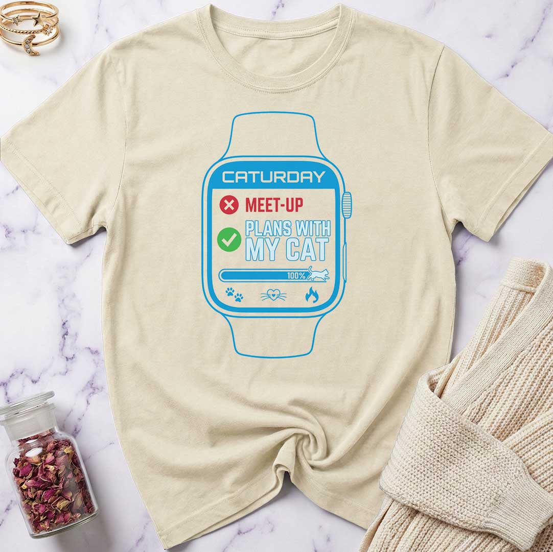Beige t-shirt with a graphic of a smartwatch and text on a marble surface.