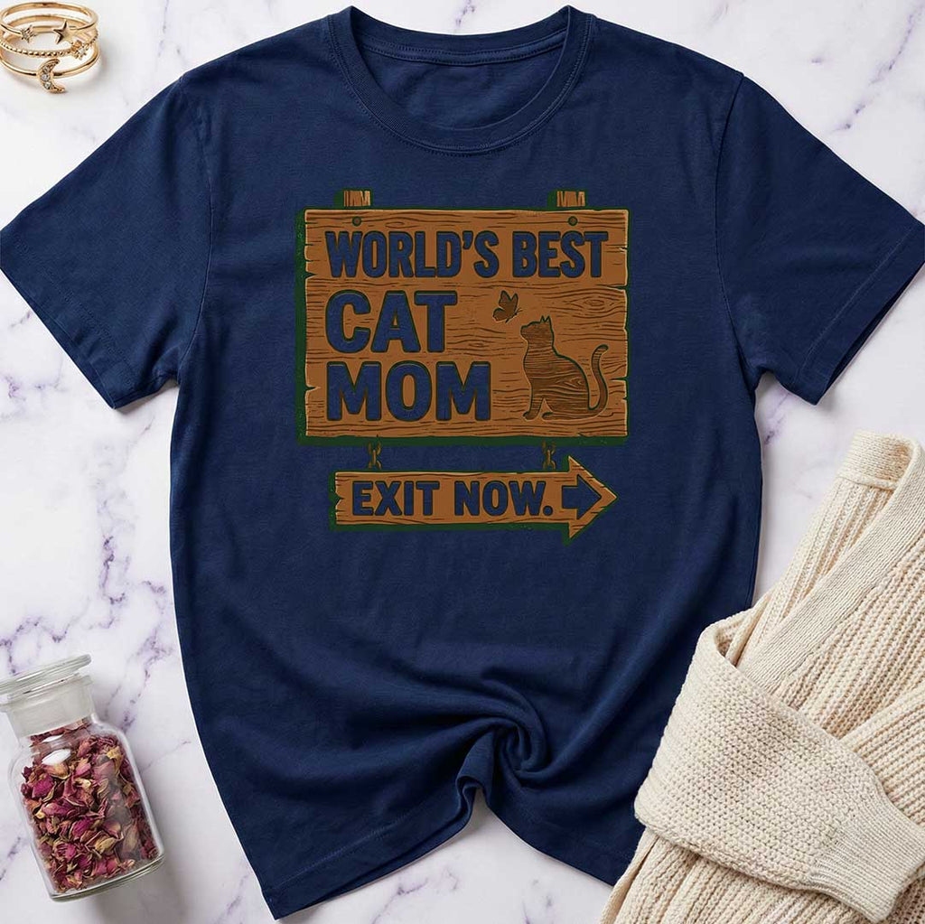 Navy blue t-shirt with 'World's Best Cat Mom Exit Now' text on a marble surface.
