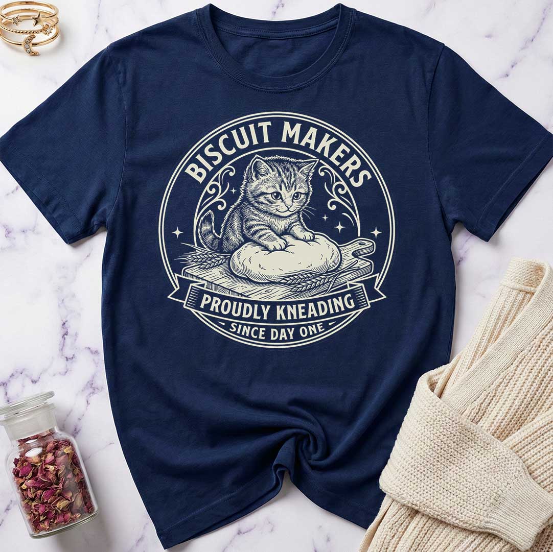 Navy blue t-shirt with a cat graphic and text on a marble surface.