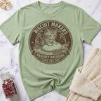 Green t-shirt with a cat graphic and text on a marble surface