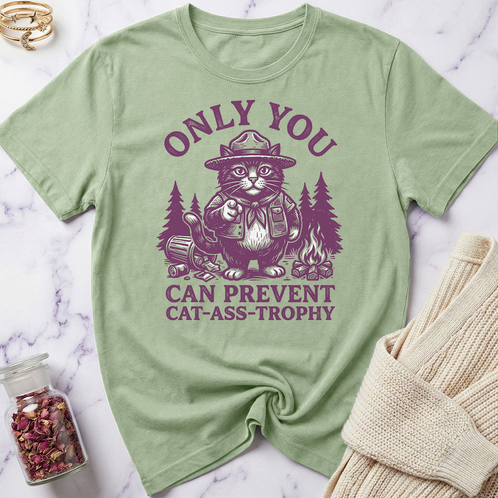 Green t-shirt with a graphic of a cat in a hat and text on a marble surface.