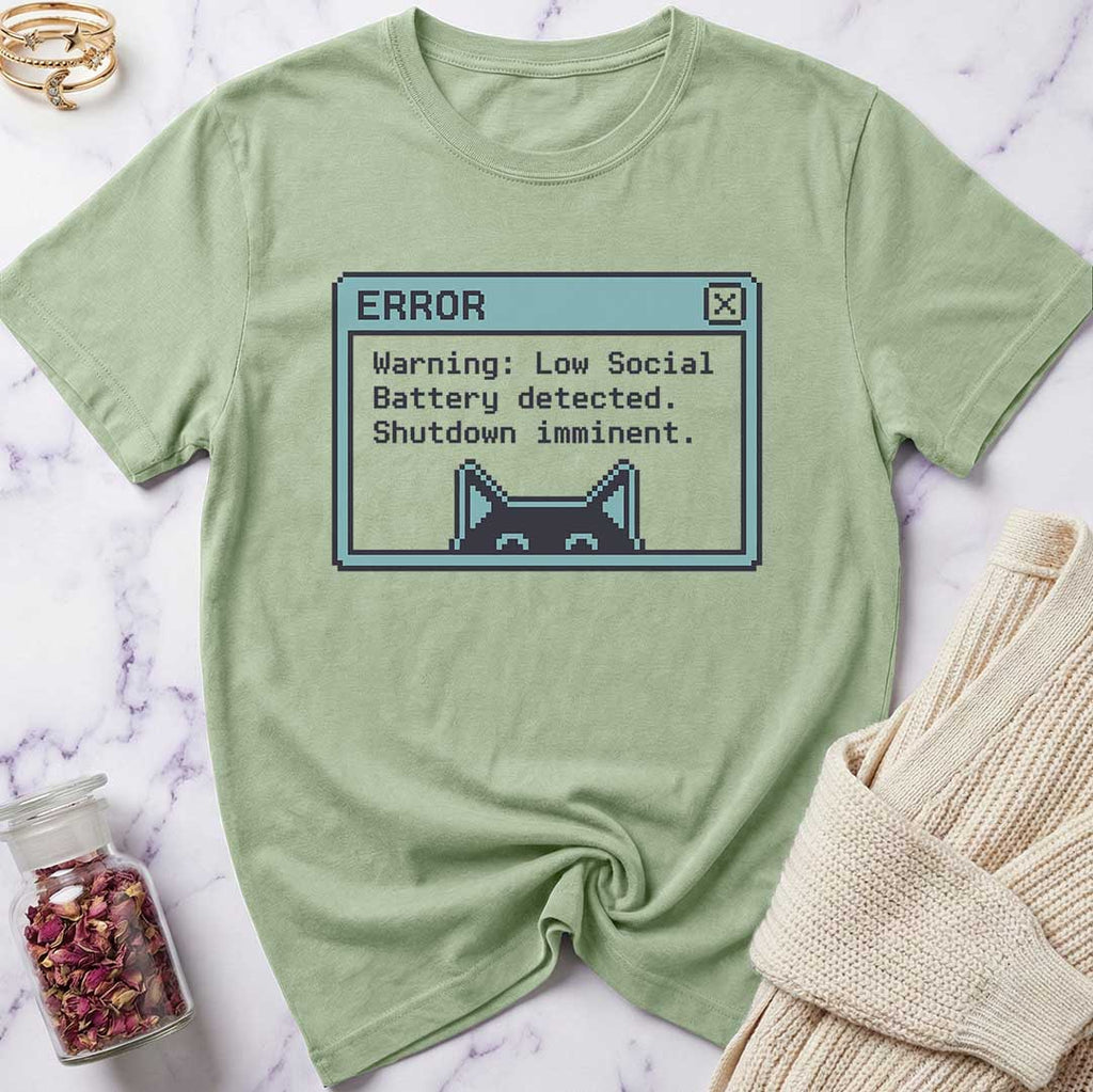 Green t-shirt with a pixelated error message design on a marble surface.