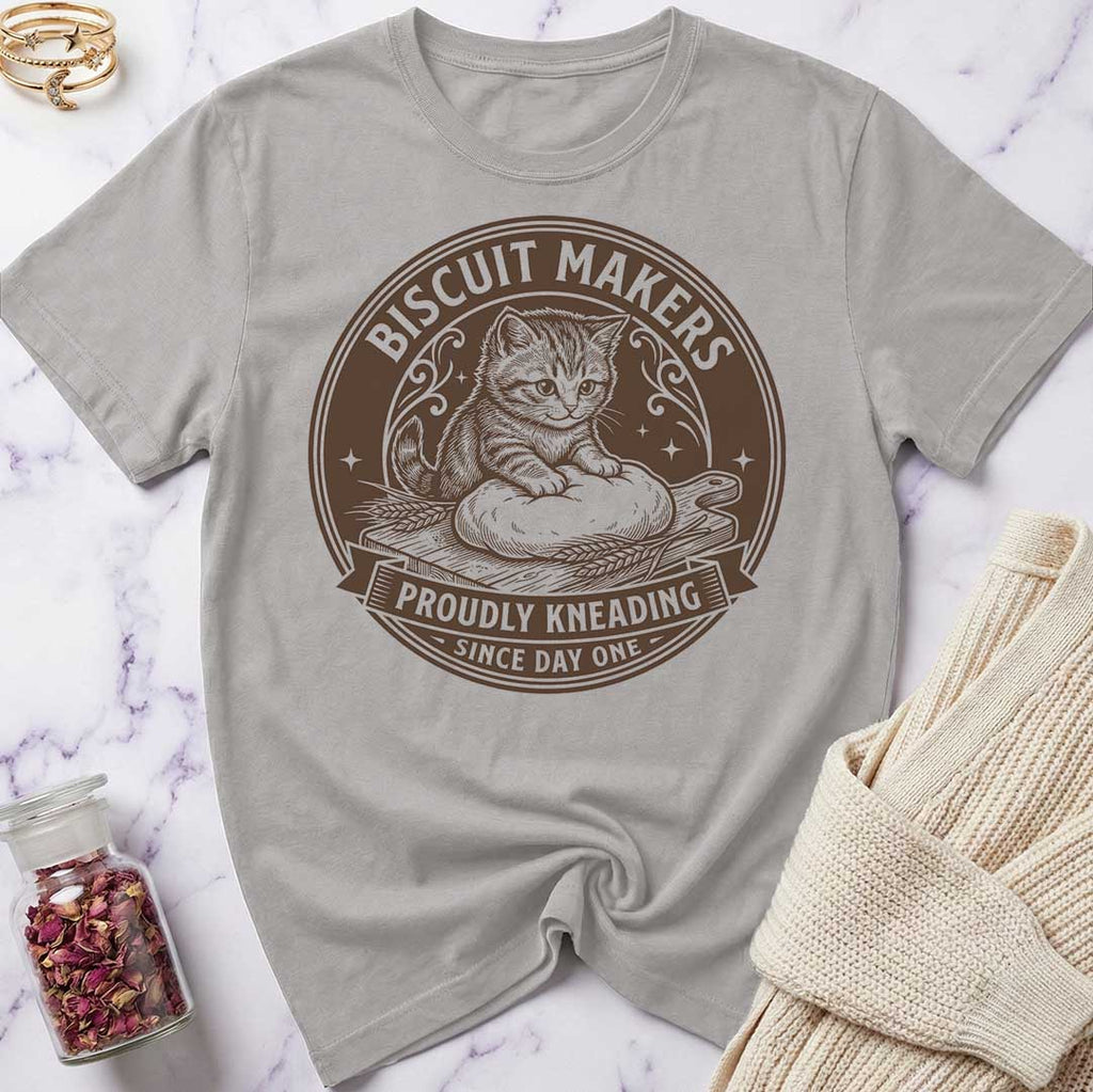 Gray t-shirt with a cat graphic and text on a marble surface