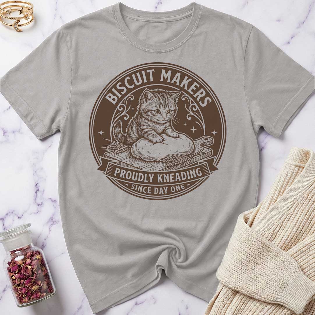 Gray t-shirt with a cat graphic and text on a marble surface