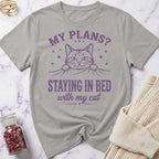 Gray t-shirt with a cat graphic and text on a marble surface