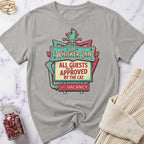Gray t-shirt with 'The Whisker Inn' graphic design on a marble surface.