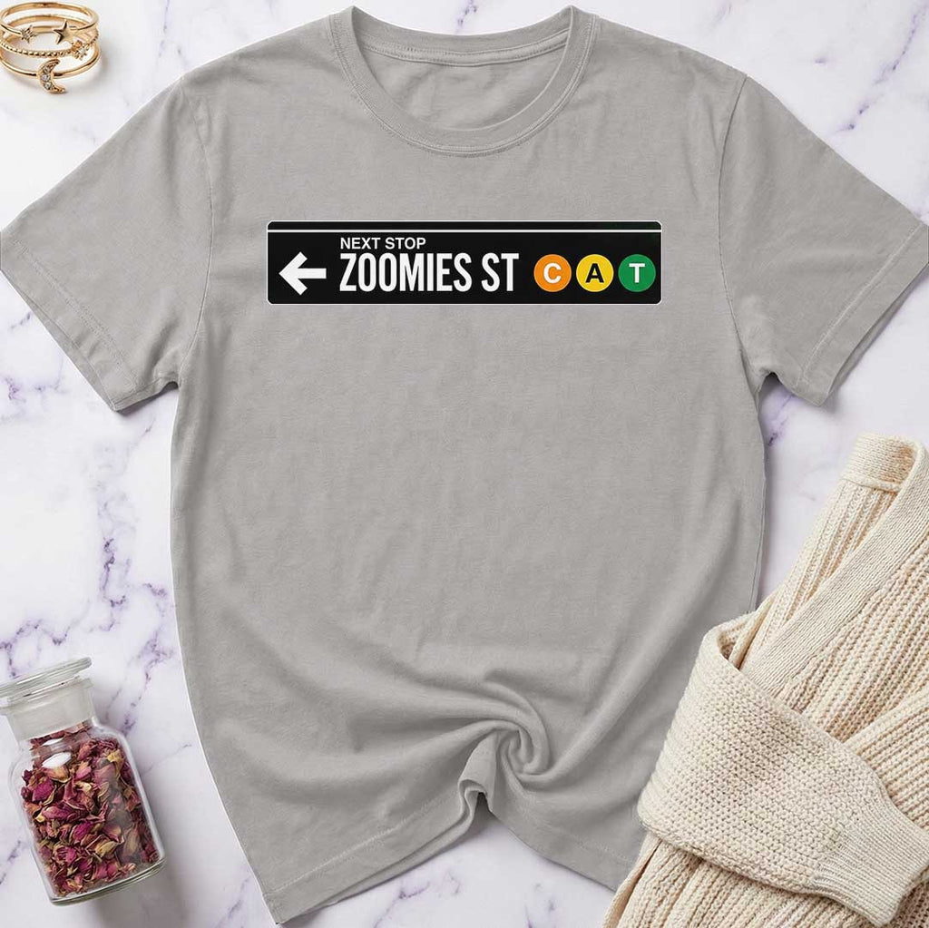 Gray t-shirt with a humorous street sign design on a marble surface.