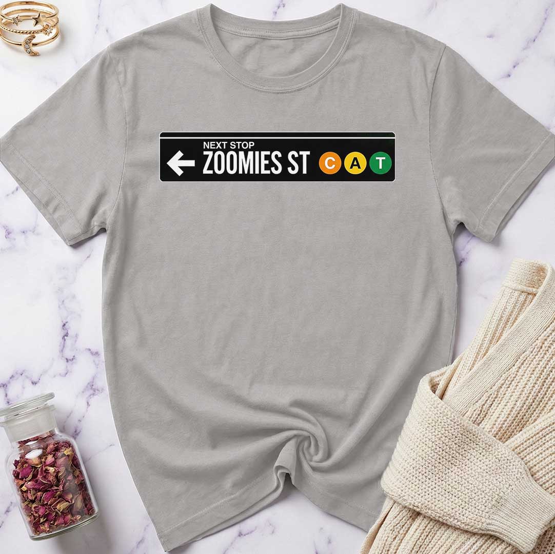 Gray t-shirt with a humorous street sign design on a marble surface.