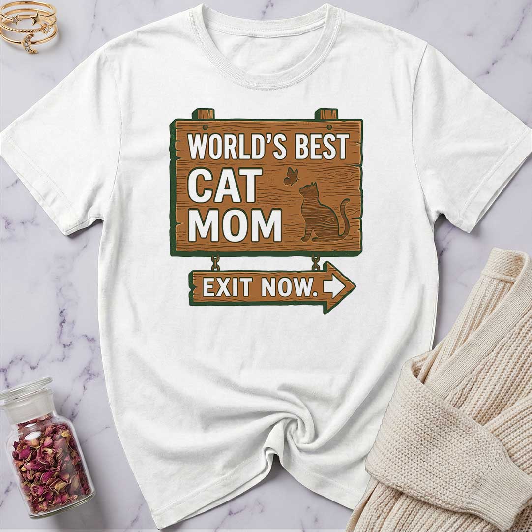White t-shirt with 'World's Best Cat Mom Exit Now' design on a marble surface.