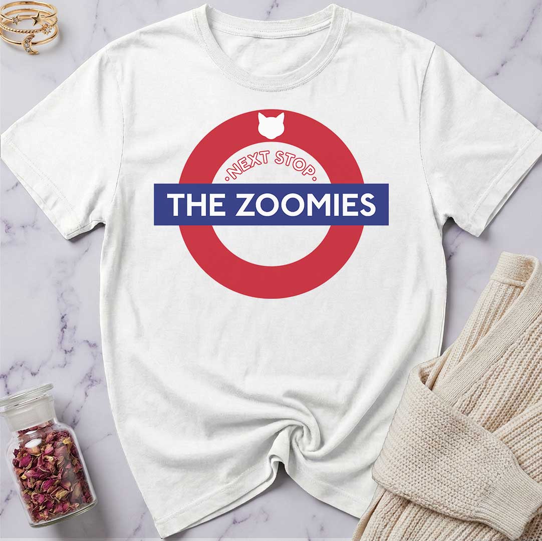 White t-shirt with 'Next Stop The Zoomies' design on a marble surface