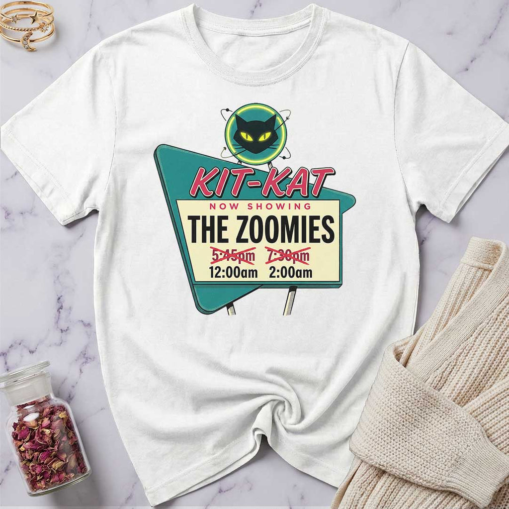 White t-shirt with a movie theater-themed graphic on a marble surface.