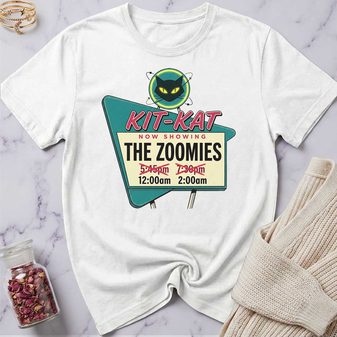 White t-shirt with a movie theater-themed graphic on a marble surface.